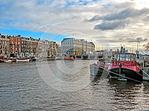 Reflection of Amsterdam famous duch traditional Flemish brick buildings, city canal in Holland, Netherlands